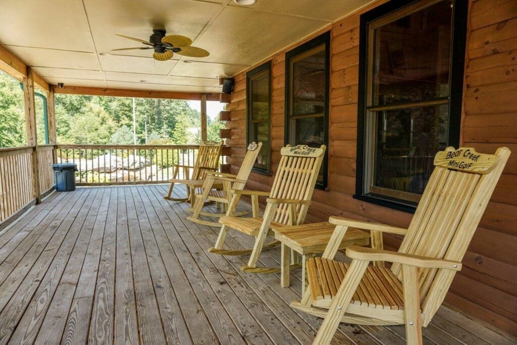 a wooden porch with chairs on it