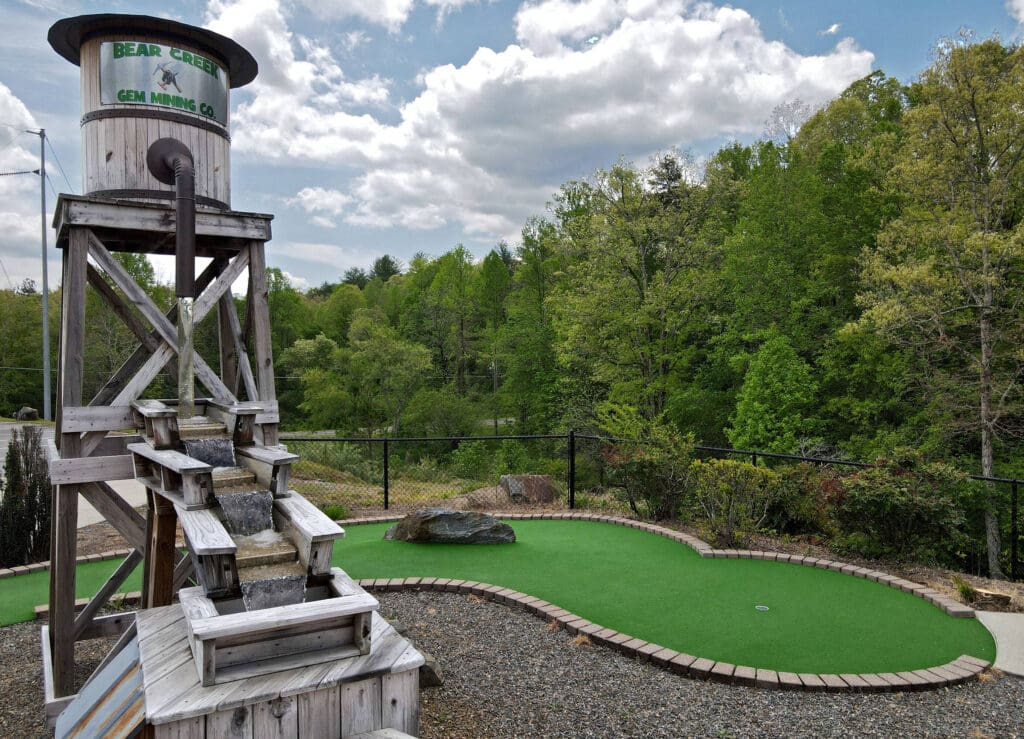 a miniature golf course with a water tower